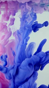 Abstract Shot of Blue and Pink Ink Droplets Creating Swirling Patterns in Water Against White Background with Soft Lighting for Adobe Stock
