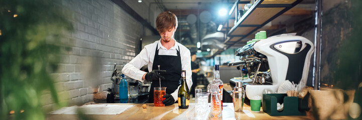 Bartender Mixing Cocktail in Wide Banner with Copy Space
