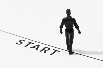 Human figurine walking on the start line. Concept of new year, career, change or challenge
