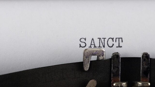 The word SANCTIONS is typing on a retro typewriter.
