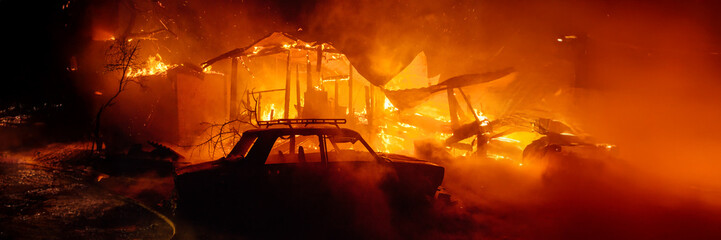 House on Fire with Car in Foreground Wide Banner