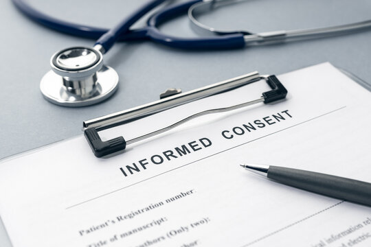 Informed Consent form and stethoscope on desk - Powered by Adobe