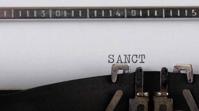 The word SANCTIONS is typing on a retro typewriter.
