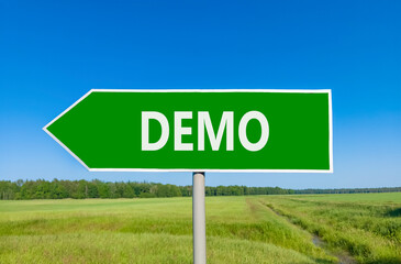Demo symbol. Concept word Demo on beautiful green road sign. Beautiful blue sky green grass and...