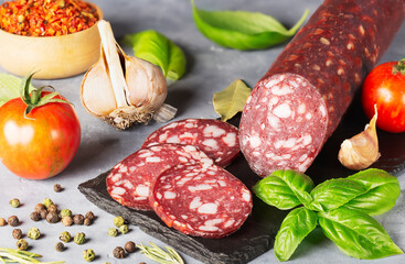 dry sausage sliced with spices and basil