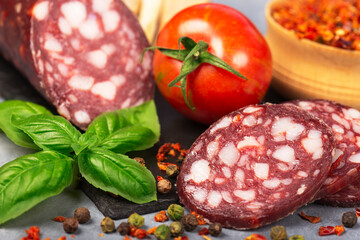 dry sausage sliced with spices and basil