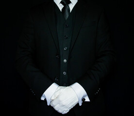 Formal Butler or Hotel Concierge in Dark Suit and White Gloves Standing at Attention. At Your Service.