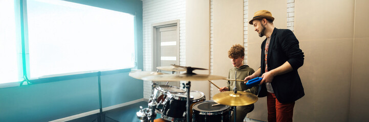 Music Lesson with Drum Teacher and Student Wide Banner