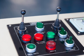 A control panel for a sea ship with various buttons, levers and switches. © Сергей Жмурчак