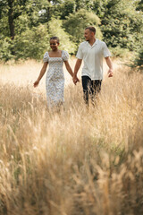 Romantic diverse couple embracing in nature, enjoying summer together, lifestyle and love concept,...