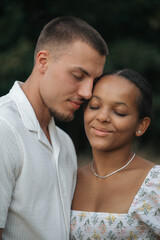 Fototapeta premium Affectionate moment of an interracial couple, close-up portrait of love, joy and authentic emotions.