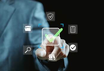 Businessman writing digital check mark icon for approval and quality assessment on digital...