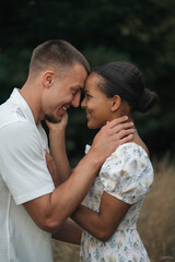 Affectionate moment of an interracial couple, close-up portrait of love, joy and authentic emotions.