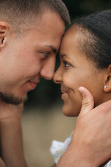 Fototapeta premium Affectionate moment of an interracial couple, close-up portrait of love, joy and authentic emotions.