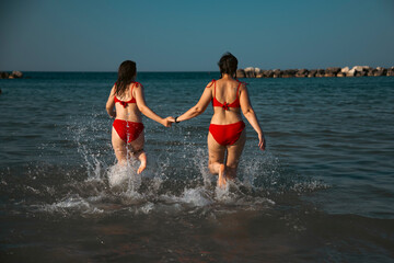 Mother and daughter having fun on the beach.
