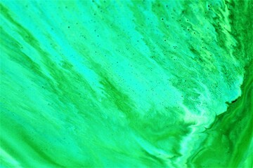 Fototapeta premium abstract background of green watercolor paint on paper close-up