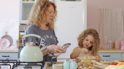 Mother and daughter preparing breakfast in slow motion