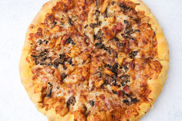 Freshly baked pizza with mushrooms bacon and chicken on light white background ready to eat