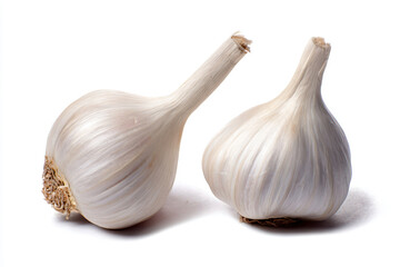 Fototapeta premium two garlic bulbs on a white surface