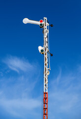 Old railway semaphore against blue sky. Close-up.