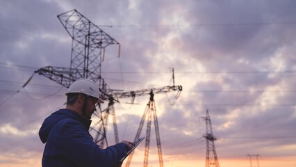 Worker energy worker conducts repairs of power engineering with a tablet, preventive work of an engineer, electricity under voltage network, planet business technologies concept. © TO LOVE