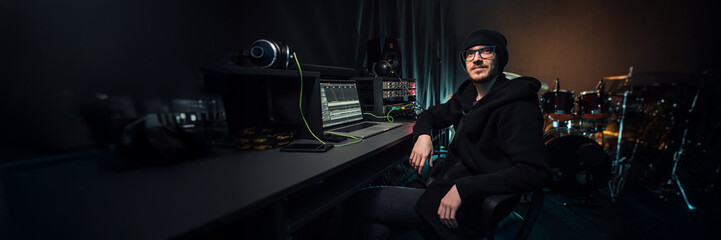 Music Producer in Studio Setting Wide Banner