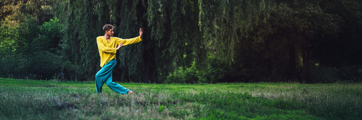 Man Practicing Tai Chi in Forest Wide Banner with Copy Space
