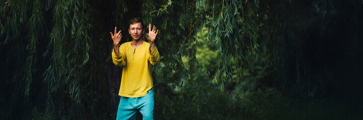 Man Gesturing in Nature Wide Banner with Copy Space