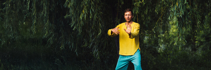Man Practicing Tai Chi in Nature Wide Banner with Copy Space