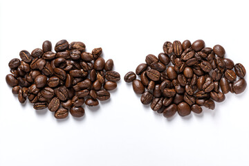 two pieces of coffee beans on a white surface