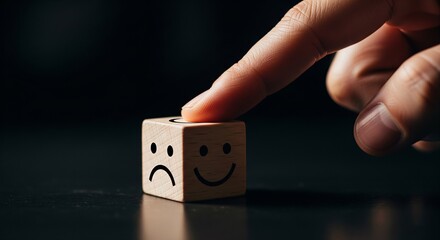 Choosing Emotional Facets: A finger delicately interacts with a wooden block, showcasing a visual metaphor of shifting between sad and happy emotions.