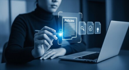Digital Policies: A person interacts with an augmented reality interface overlaying a laptop, symbolizing the modern approach to policy management and information processing.