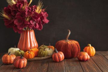 Autumnal composition of decorative mini pumpkins on a wooden surface.