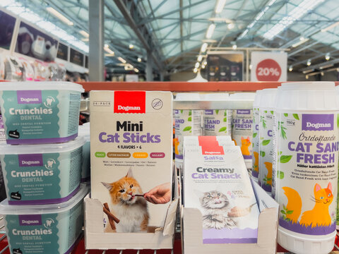 Porsgrunn, Norway - June 15, 2025: Dogman pet products display featuring Mini Cat Sticks, Creamy Cat Snack, and Cat Sand Fresh in a vibrant retail environment with colorful packaging