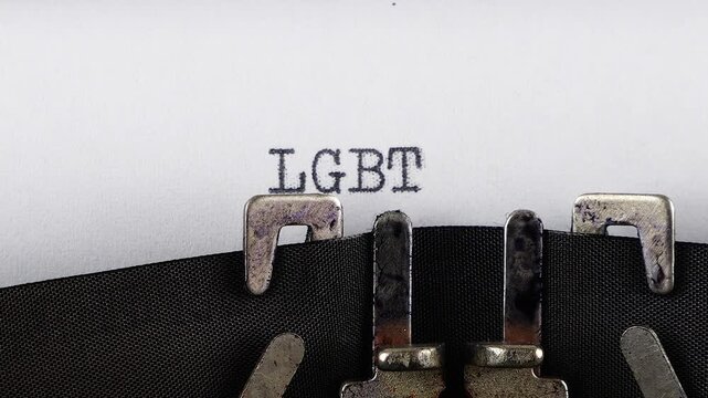The abbreviation LGBT is typing on a retro typewriter.