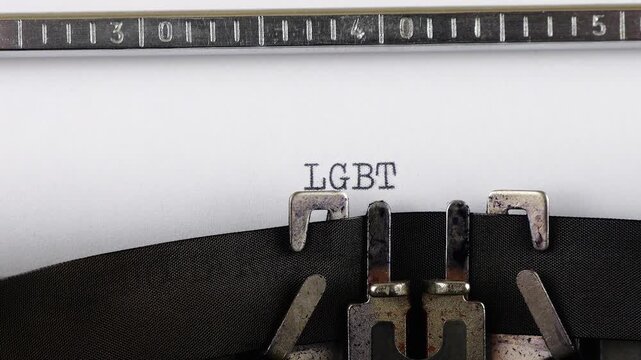 The abbreviation LGBTQ+ is typing on a retro typewriter.