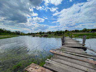 Fototapeta premium Old Wooden Pier Over a Calm Rural Lake