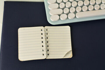 Notebook and pencil placed on dark textured surface