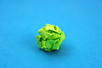 Crumpled green paper, discarded idea