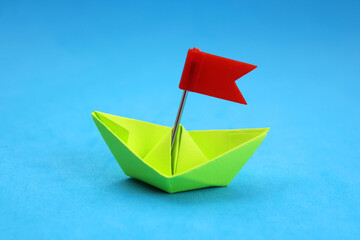 Origami paper boat with flag