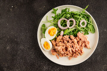 Tuna salad egg, arugula, vegetables tasty snack fresh delicious gourmet food background on the table rustic food top view copy space keto and paleo diet food pescetarian diet