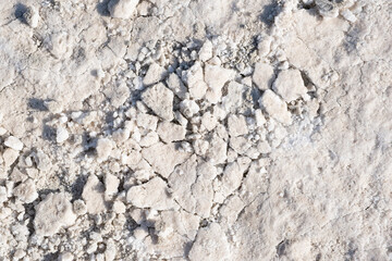White salt Salt covering ground creating unique textured surface with cracks. Nature background abstract