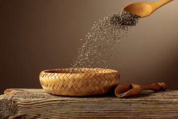 Chia seeds are poured into a wicker bowl.