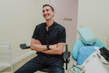 The smiling doctor in the dentist's office. Specialist in oral cavity treatment. A doctor in a...