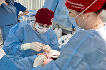 Surgical team performing a delicate procedure in a sterile operating room