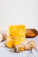Natural homemade rejuvenating soap with turmeric on the table vertical view