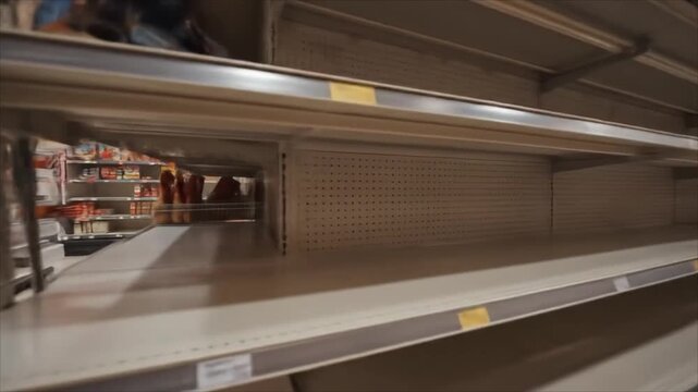 Empty food shelves in grocery store with no products displayed  
