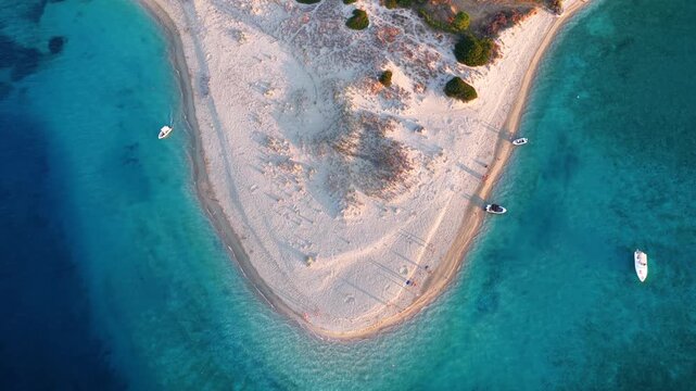 Aerial top down view of the beach of Marathonisi or so called Turtle island, Zakynthos, Greece, during sunset time with turquoise sea