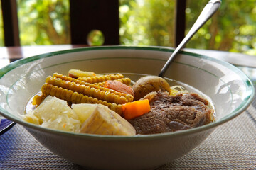 Close-up of a typical Costa Rican soup called Olla de Carne, a typical Costa Rican dish with white rice, chayote potatoes, carrots, and green plantains. Beef soup with vegetables,mexican soup