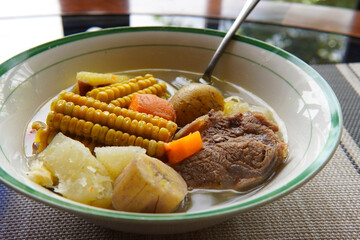 Close-up of a typical Costa Rican soup called Olla de Carne, a typical Costa Rican dish with white rice, chayote potatoes, carrots, and green plantains. Beef soup with vegetables,mexican soup